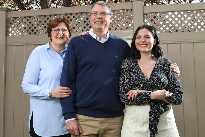  Vice-Admiral Mark Norman, his wife Beverly and his daughter Holly pose for a photo their home in Ottawa Thursday May 16, 2019.