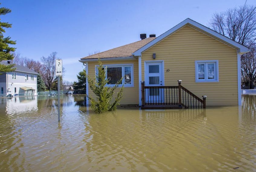 An abandoned house in the flooded Pointe-Gatineau neighbourhood of the city on Sunday.