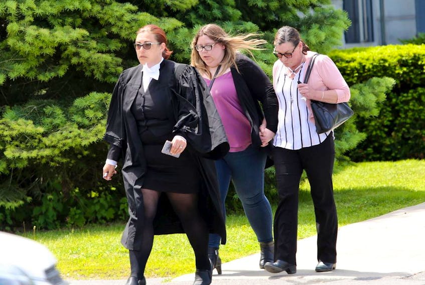Kirsten Pemberton, centre, holds hands with her mother, Alicia Pemberton, with lawyer Dawn Quelch out of the Lennox and Addington County Court House at the end of the final day of Pemberton's sentencing in Napanee on Wednesday, June 12, 2019.