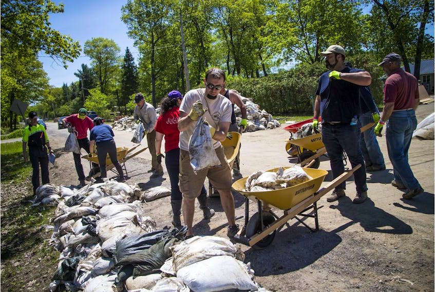 Volunteers, city staff and area residents were out working to clean up the sandbags in Constance Bay Saturday June 8, 2019.   