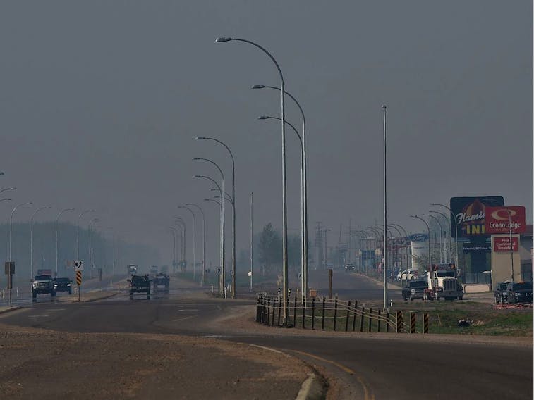 Smoke moved along Highway 35 in High Level Sunday where about 4,000 residents were evacuated from the town site due too the Chuckegg Creek wildfire.