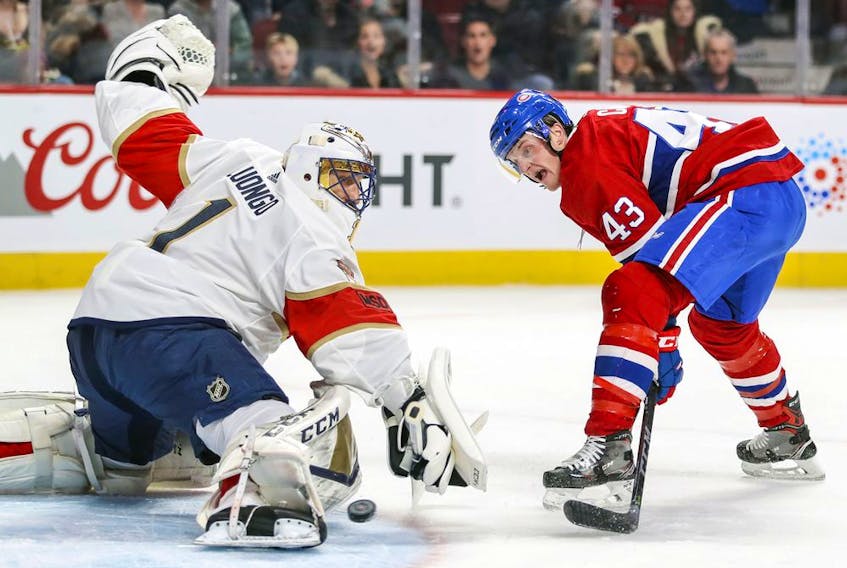  Montreal Canadiens’ Charles Hudon holds off Florida Panthers’ Aleksander Barkov during first period in Montreal on March 19, 2018.