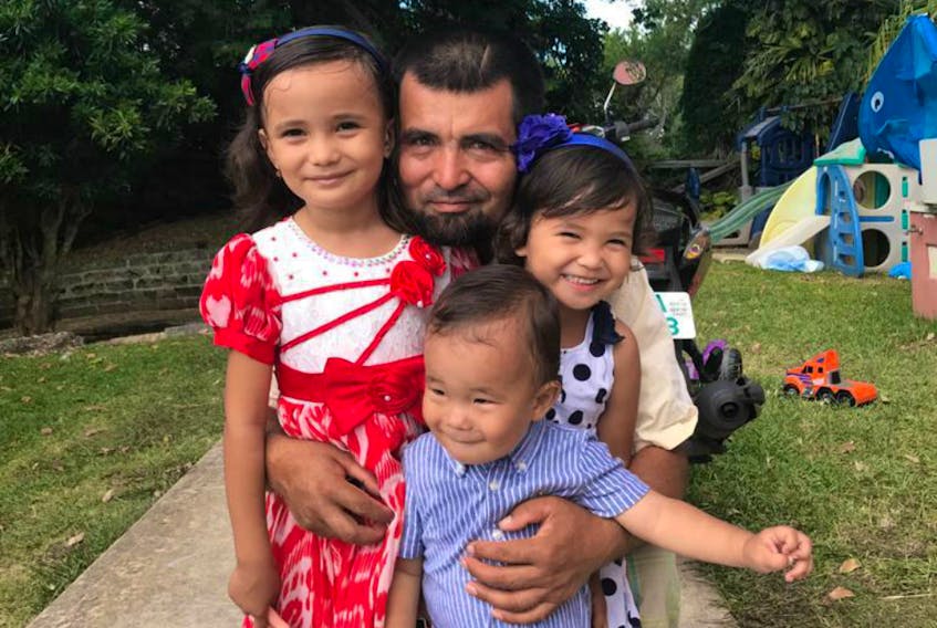 Salahadin Abdulahad with his three children in Bermuda, where he was sent after being cleared of terrorism suspicions and freed from the Guantanamo Bay detention facility in 2009. He has applied to emigrate to Canada as his wife and children are living in Toronto.