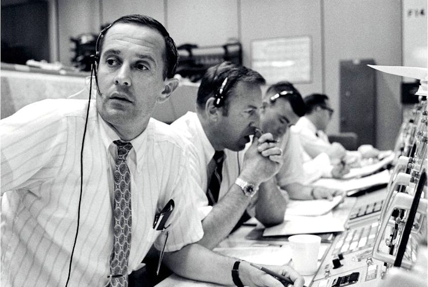 Charles Duke, left, was the capsule communicator for the Apollo 11 mission.