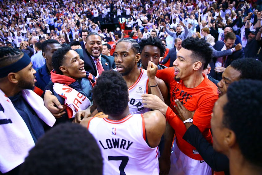 Kawhi Leonard celebrates with Toronto Raptors teammates after winning Game 7 on Sunday. (GETTY IMAGES)