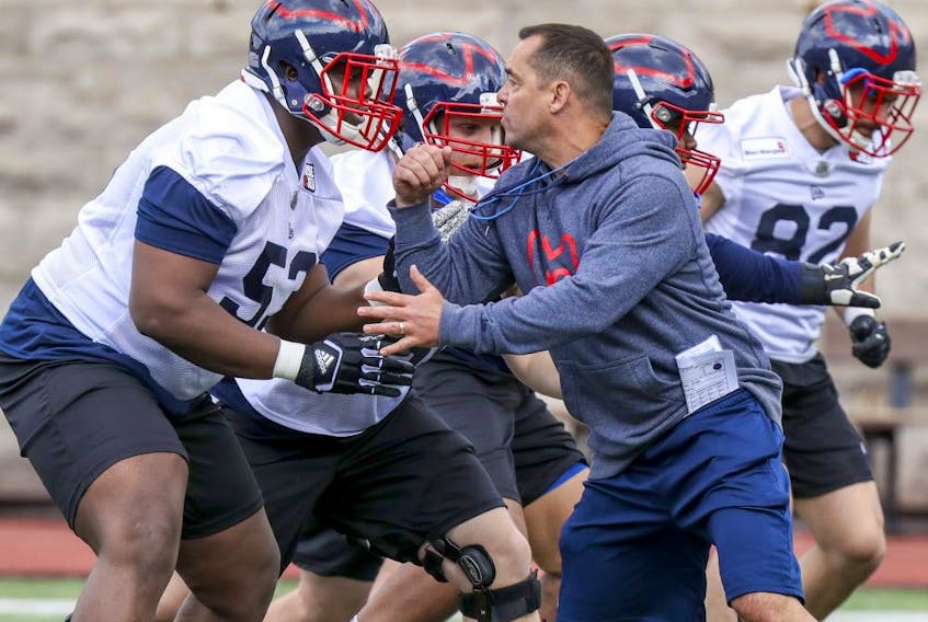  Montreal Alouettes assistant coach André Bolduc takes on offensive-lineman Jarvis Harrison during first day of rookie camp in Montreal on May 15, 2019.