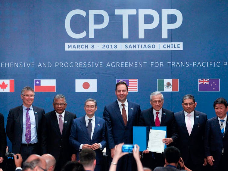 Representatives from member countries, including Canada's International Trade Minister Francois-Phillippe Champagne (third from left), pose after signing the Comprehensive and Progressive Agreement for Trans-Pacific Partnership on March 8, 2018.