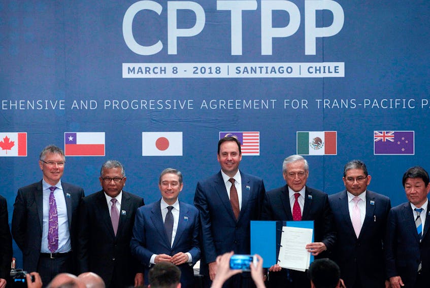 Representatives from member countries, including Canada's International Trade Minister Francois-Phillippe Champagne (third from left), pose after signing the Comprehensive and Progressive Agreement for Trans-Pacific Partnership on March 8, 2018.