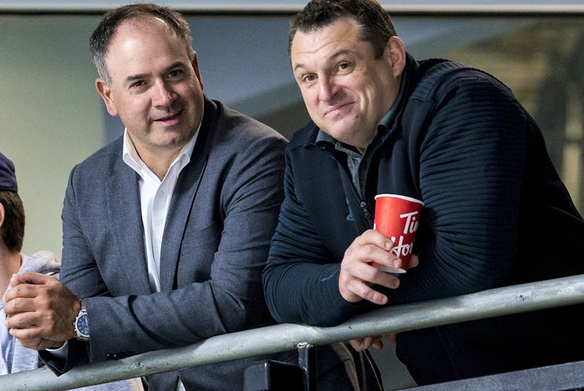 Files: General manager Pierre Dorion (L) and new head coach DJ Smith watch their players at the Ottawa Senators development camp at the Bell Sensplex on June 27, 2019. 