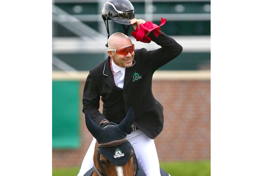 Eric Lamaze salutes the crowd as he rode Fine Lady 5 to victory in a jump off in the PwC Cup at Spruce Meadows during The National showjumping event in Calgary on Thursday. The National runs through Sunday. Photo by Jim Wells/Postmedia.
