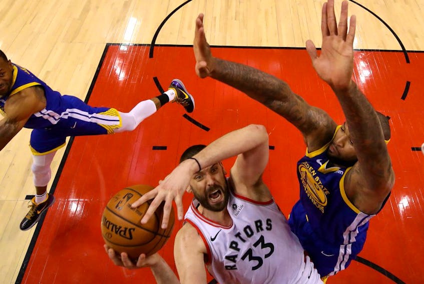 Marc Gasol #33 of the Toronto Raptors attempts a shot against DeMarcus Cousins #0 of the Golden State Warriors during Game Five of the 2019 NBA Finals at Scotiabank Arena on June 10, 2019 in Toronto, Canada. 