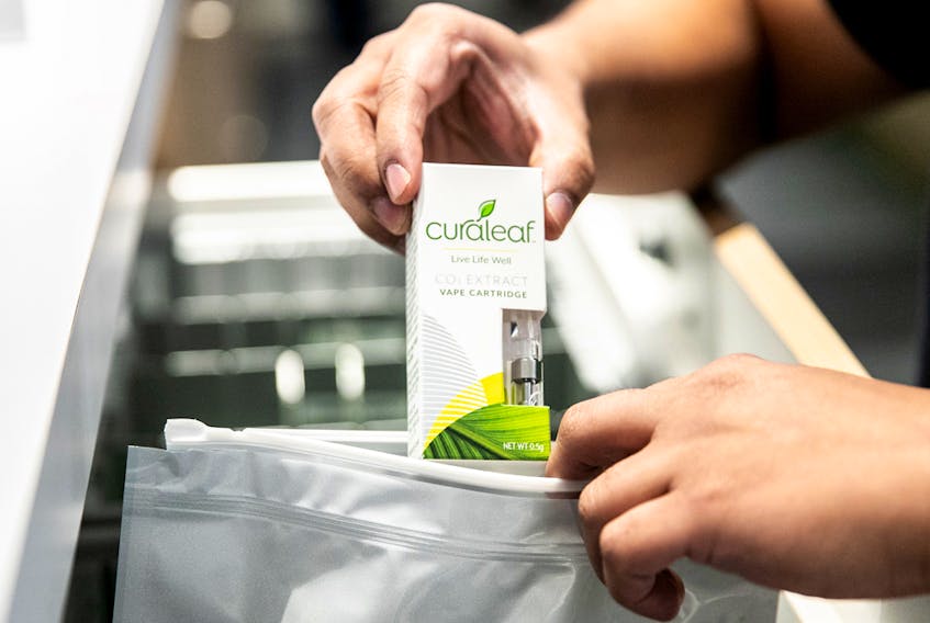 An employee puts a vape cartridge in a bag at a Curaleaf Inc. store in the Queens borough of New York.