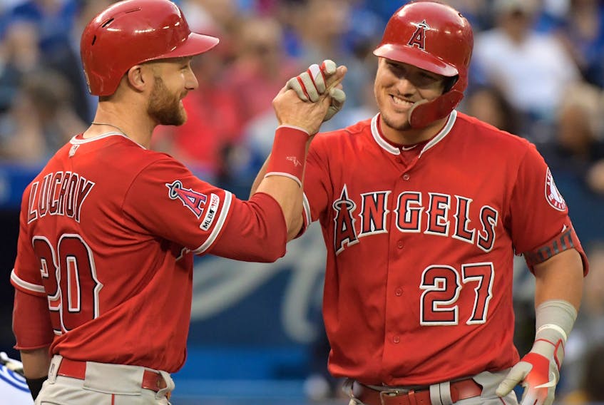Los Angeles Angels center fielder Mike Trout, right, is greeted by catcher Jonathan Lucroy after hitting a grand slam home run against Toronto Bue Jays in the fourth inning at Rogers Centre. (Dan Hamilton-USA TODAY Sports)