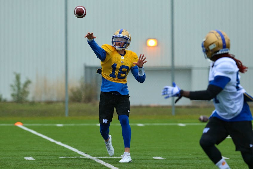 Quarterback Bryan Bennett leads receiver Lucky Whitehead with a pass during Blue Bombers rookie camp on the University of Manitoba campus on Wednesday. (KEVIN KING/WINNIPEG SUN)