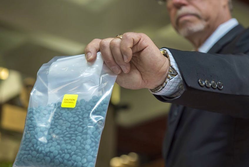 Acting Staff Sgt. Guy Pilon holds a bag of fentanyl during a July 24, 2018, press conference at Edmonton police headquarters. Alberta's Court of Appeal heard a case Wednesday on whether two fentanyl traffickers' sentences should be increased, raising the possibility of a "starting point" sentence for high-level fentanyl dealers.