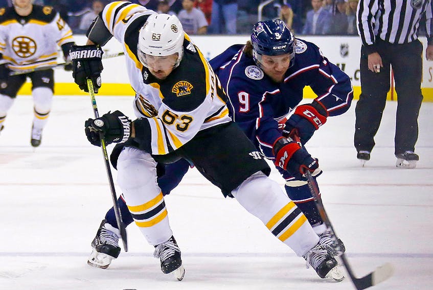 Brad Marchand of the Boston Bruins attempts to skate the puck away from Artemi Panarin of the Columbus Blue Jackets April 30, 2019 at Nationwide Arena in Columbus. (Kirk Irwin/Getty Images) 