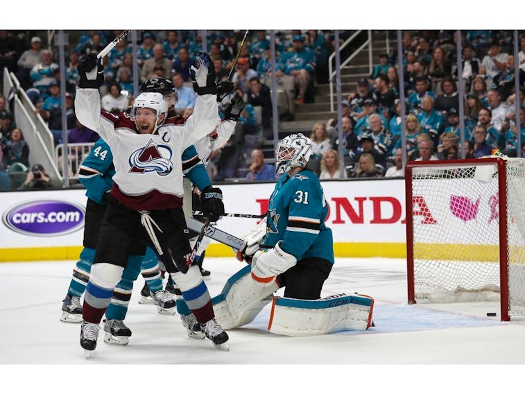 Colorado Avalanche's Gabriel Landeskog (92) celebrates a goal against San Jose Sharks goaltender Martin Jones (31) by teammate Tyson Barrie (not shown) in the second period of Game 2 of an NHL hockey second-round playoff series at the SAP Center in San Jose, Calif., on Sunday, April 28, 2019.