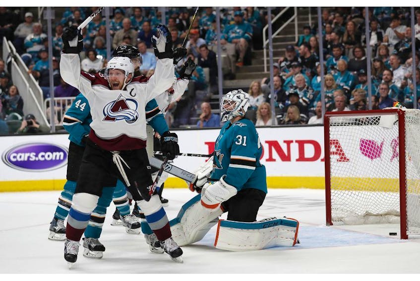 Colorado Avalanche's Gabriel Landeskog (92) celebrates a goal against San Jose Sharks goaltender Martin Jones (31) by teammate Tyson Barrie (not shown) in the second period of Game 2 of an NHL hockey second-round playoff series at the SAP Center in San Jose, Calif., on Sunday, April 28, 2019.