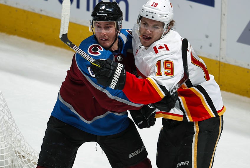 Colorado Avalanche defenseman Tyson Barrie, left, jostles for position by the net with Calgary Flames left wing Matthew Tkachuk during the first period of Game 4 of an NHL hockey playoff series Wednesday, April 17, 2019, in Denver. (AP Photo/David Zalubowski) ORG XMIT: CODZ116