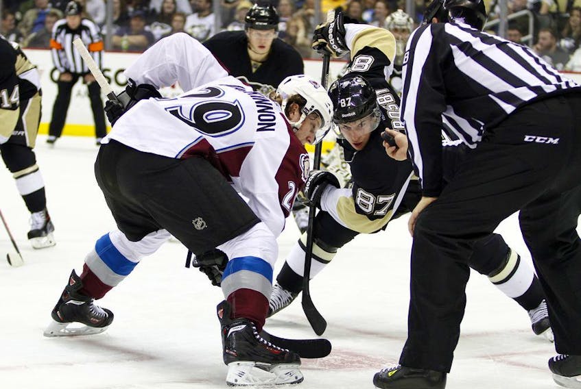 Colorado Avalanche centre Nathan MacKinnon lines up to take a draw against good buddy Sidney Crosby, of the Pittsburgh Penguins. Getty Images file photo.