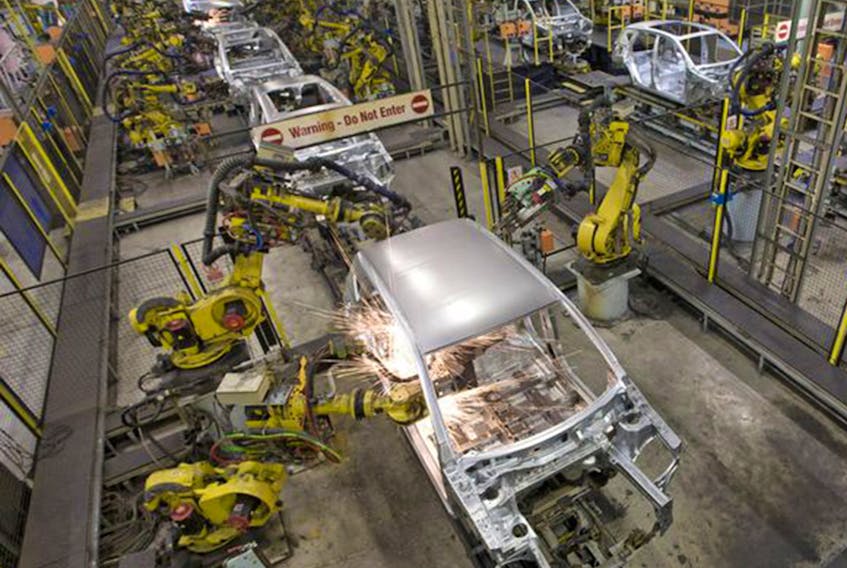 Robots weld the bodywork of new cars on an assembly line. 