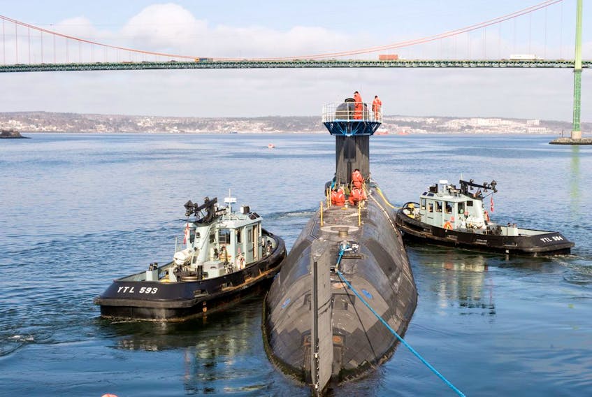Her Majesty Canadian Ship (HMCS) Chicoutimi is guided by tugs in this file photo. Ocean Industries will build four new tugs for the Royal Canadian Navy. Canadian Forces photo.