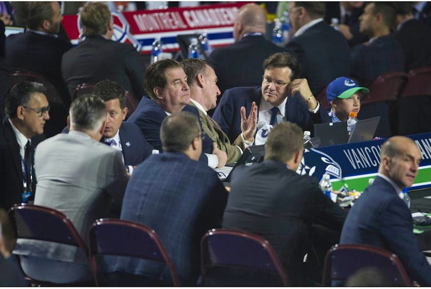 Jim Benning, Francesco Aquilini and some of the Vancouver Canucks' scouting staff at the 2019 NHL Entry Draft in Vancouver.