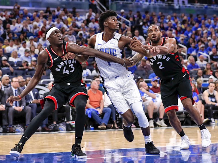 Jonathan Isaac of the  Magic getrs double-teamed down low by Raptors' Pascal Siakam (left) and Kawhi Leonard during Game 4 at the Amway Center on April 21, 2019 in Orlando, Florida. The Raptors defeated the Magic 107-85. (Photo by Don Juan Moore/Getty Images)