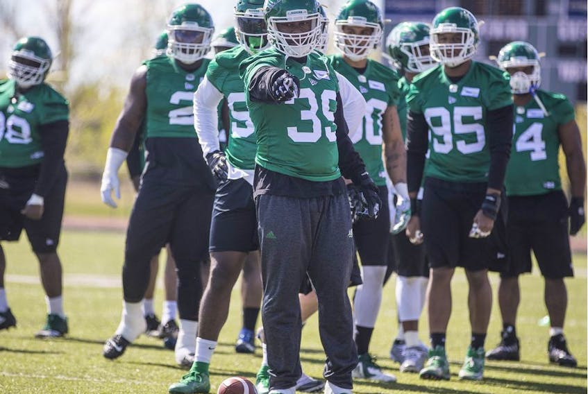 Defensive end Charleston Hughes (39) worked on drills during the Saskatchewan Roughriders' training camp after dealing with questions regarding the new collective bargaining agreement.