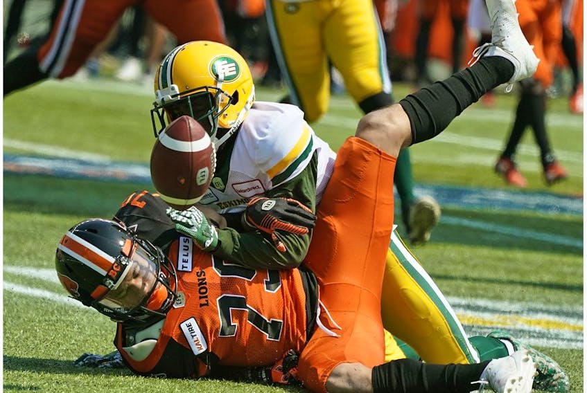  Former Redblack Nick Taylor, now with the Eskimos, tackles the Lions’ Jesse Walker during a CFL pre-season game at Edmonton on Sunday.