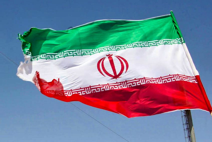 The Iranian flag flutters.