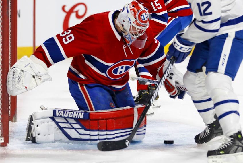 Canadiens goaltender Charlie Lindgren looks for a lose puck as Toronto Maple Leafs'  Patrick Marleau looks for the rebound in Montreal on Saturday, April 6, 2019. 