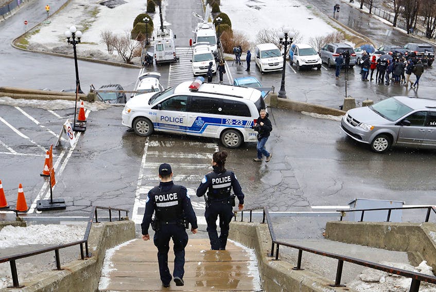Montreal police officers at the scene of a stabbing at St. Joseph's Oratory March 22, 2019. Father Claude Grou was hospitalized and returned to saying mass a week later.
