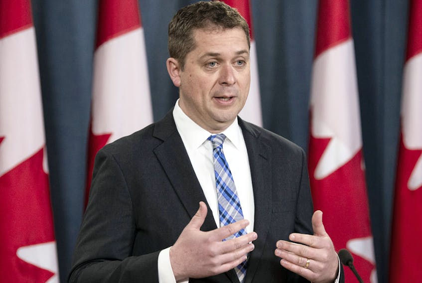  Opposition Leader Andrew Scheer listens as a reporter asks a question during a news conference in Ottawa, April 14, 2020.