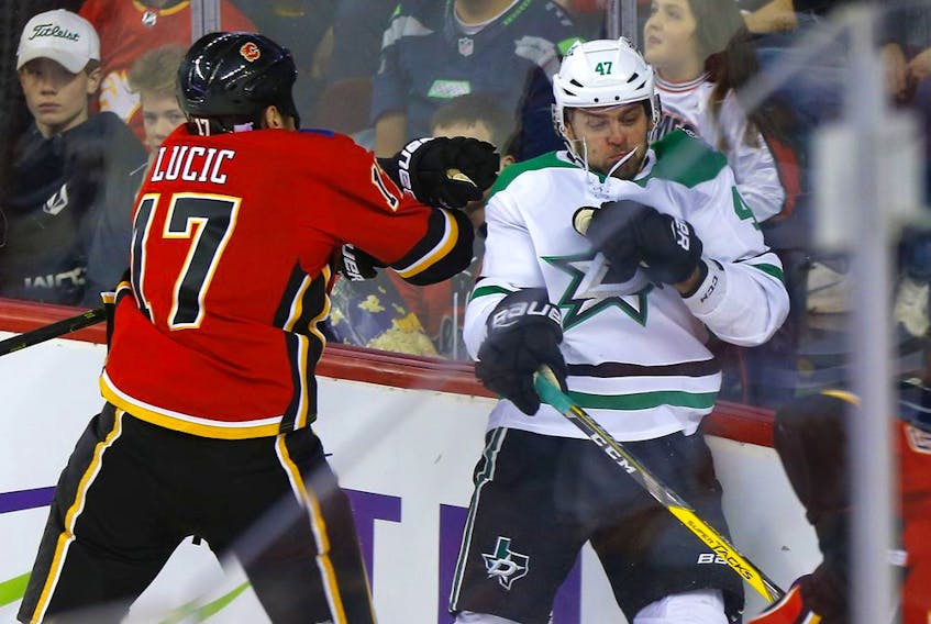 Calgary Flames, Milan Lucic battles Dallas Stars, Alexander Radulov in first period action of at the Scotiabank Saddledome in Calgary on Wednesday, November 13, 2019. Darren Makowichuk/Postmedia