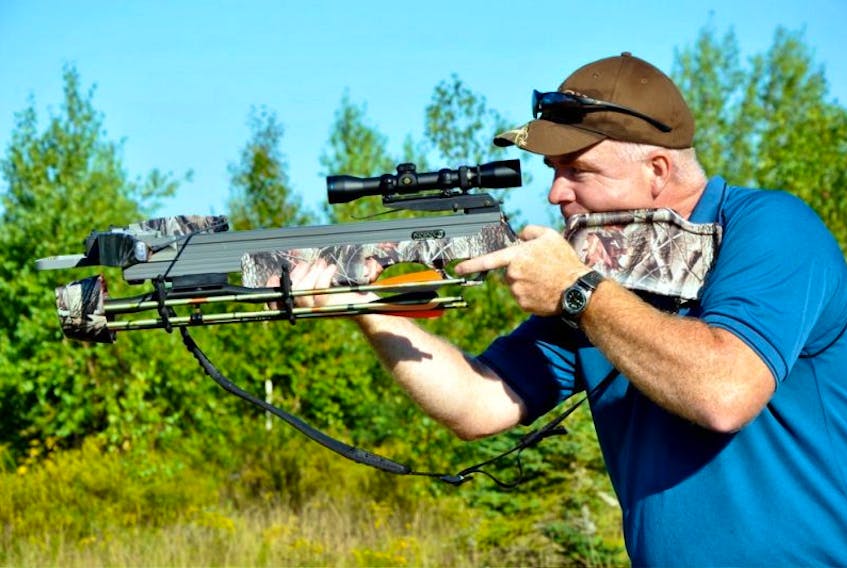 Ian Avery of the Nova Scotia Crossbow Association takes aim at a target during a demonstration. (Ashley Thompson photo)