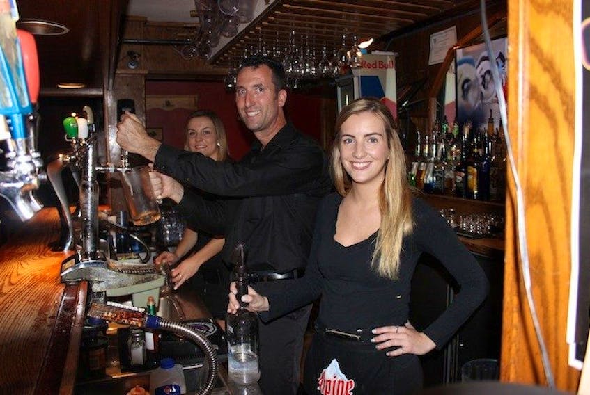 <span>Jenna Smith, back, Jeff Sinnott and Emily MacDonald stand ready to serve customers at Hunters Ale House, one of the many establishment that sees boosts from the sports tourism industry. </span>