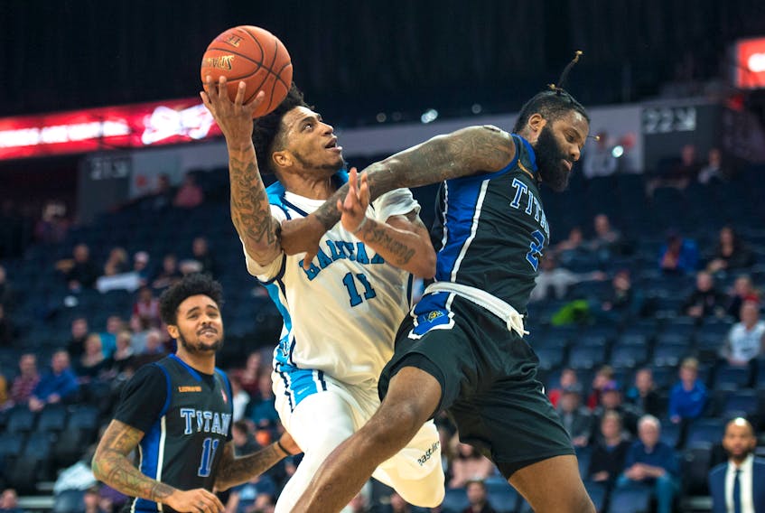 Halifax Hurricanes power forward Jordan Washington is fouled by KW Titans forward Akeem Ellis as he drives to the hoop during the first half of Wednesday night’s NBL Canada game at the Scotiabank Centre. (Ryan Taplin/The Chronicle Herald)
