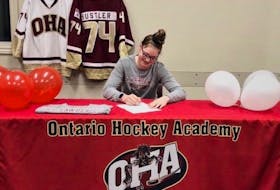 Abby Hustler signs her commitment to attend St. Lawrence University recently. Hustler, a native of St. Louis, P.E.I., is in her senior year of high school at the Ontario Hockey Academy (OHA) in Cornwall.
