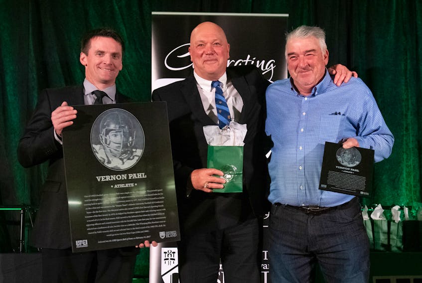 Vernon Pahl was recently inducted into the UPEI Sports Hall of Fame. From left are athletics director Chris Huggan, Pahl and his former teammate Mike Lyriotokis.