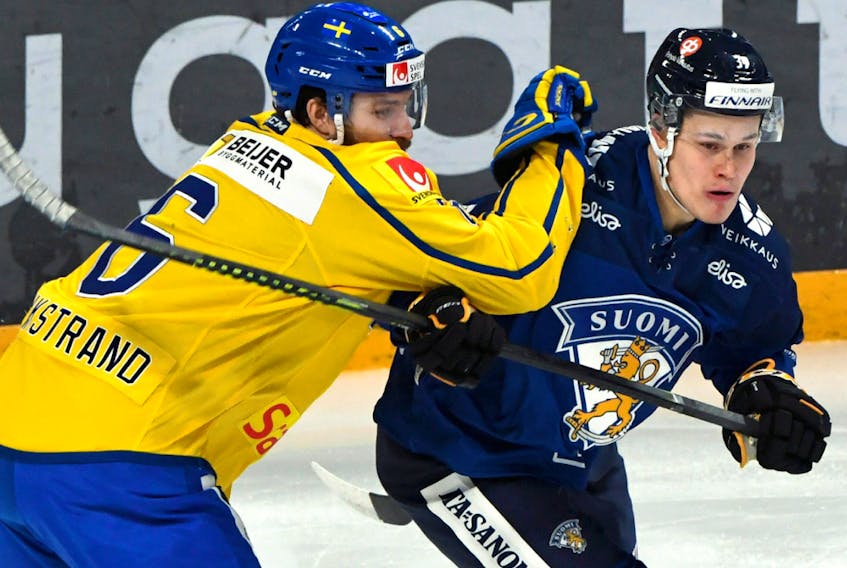 Sweden's Mikael Wikstrand skates against Finland's Jesse Puljujarvi in the Euro Hockey Tour's Karjala Cup on Finland Nov. 10, 2019.