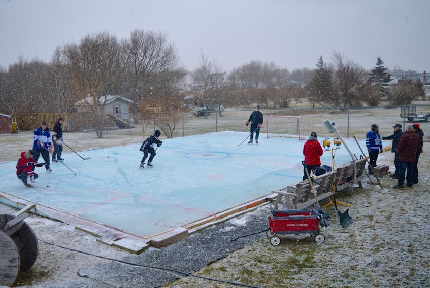 This backyard rink has become a centre for outdoor activity in an oceanside neighbourhood in Dominion. The 55-by-35 foot ice surface was built and maintained by Scott McCulloch and son Riley Turnbull. The family, including Riley’s mother Melinda, has opened up their backyard winter wonderland to friends and neighbours. The venue also includes a rink-side fire pit, benches and lights that enable evening use. More coverage A6. DAVID JALA/CAPE BRETON POST