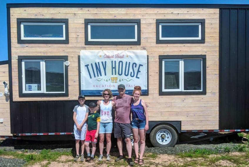 The Page family proudly stands in front of one of the tiny houses that will soon be available for holiday rentals. The new family business is called Cabot Trail Tiny House Vacation Rentals. From left, Isaish, Eli, Kate, Dan and Madelyn show off the “Boat House” at its Belle Cote location on the Cabot Trail. CONTRIBUTED 