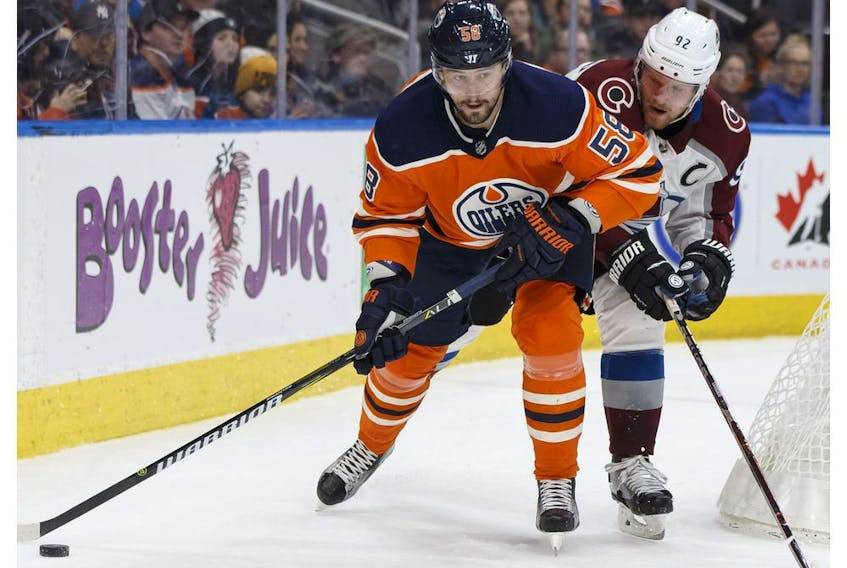 Edmonton's Anton Slepyshev (58) battles Colorado's Gabriel Landeskog (92) during the first period of a NHL game between the Edmonton Oilers and the Colorado Avalanche at Rogers Place in Edmonton, Alberta on Thursday, Feb. 22, 2018. 