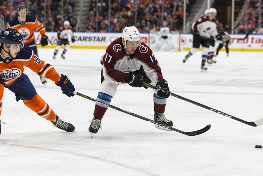 Edmonton Oilers' Matt Benning (83) reaches for Colorado Avalanche's Tyson Jost (17) at Rogers Place in this file photo taken Feb. 22, 2018.