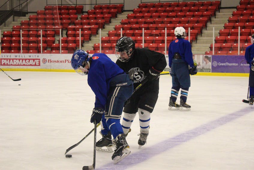 Kenzie Carew, left, and Keagan Corbett of the Sydney Sooners Peewee AAA hockey team are pictured during a practice on Monday, Dec. 10, at the Membertou Health and Wellness Centre.