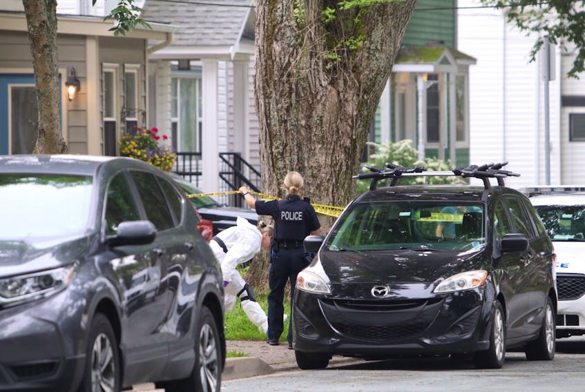 Police work at a house on Cork Street in Halifax on Thursday morning, July 2, 2020, after three people were wounded, two critically, in a shooting Wednesday night.