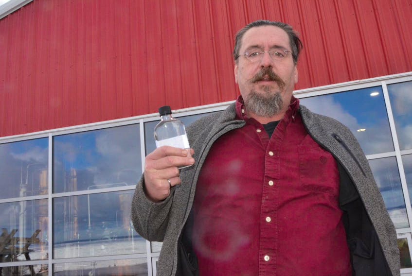 Thomas Steinhart, owner of Steinhart Distillery, holds a mickey bottle of hand sanitizer Monday, March 16, 2020 that his business has started to produce at the Arisaig, Antigonish County, facility.