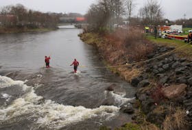 Searchers work in the Salmon River beside the Stanfield ball field in Truro on Thursday, May 7, 2020, as the look for Dylan Ehler, a three-year-old boy who went missing the day before.
