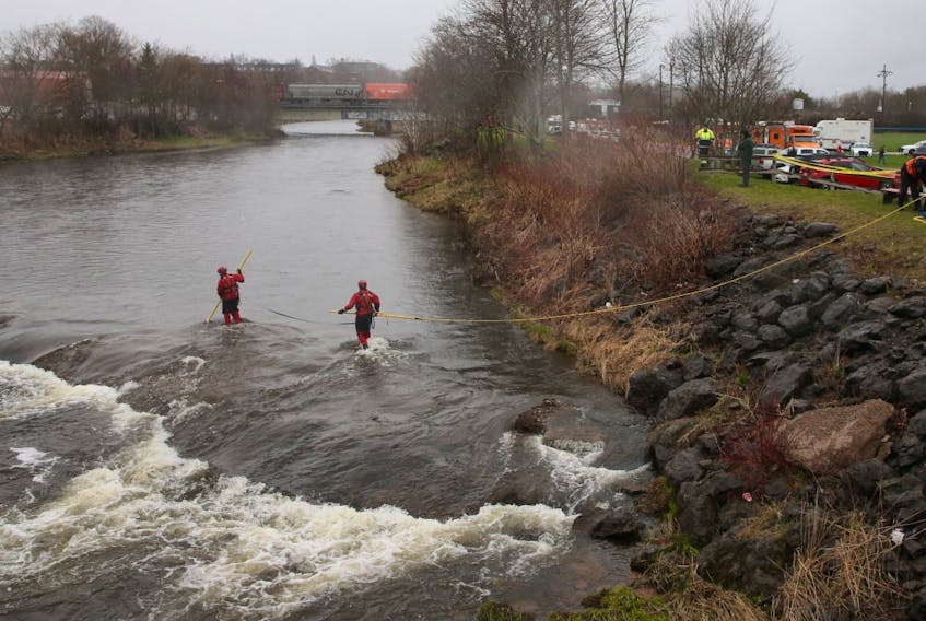 Searchers work in the Salmon River beside the Stanfield ball field in Truro on Thursday, May 7, 2020, as the look for Dylan Ehler, a three-year-old boy who went missing the day before.